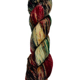 A skein of hand-dyed fingering/sock yarn color brown black red green speckles