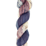 A skein of hand-dyed fingering/sock yarn color mauve white grey black speckles