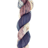 A skein of hand-dyed fingering/sock yarn color mauve white grey black speckles