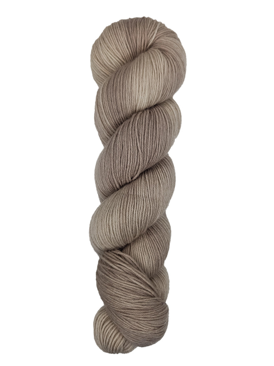 A skein of hand-dyed fingering/sock yarn color off-white and grey 
