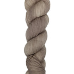 A skein of hand-dyed fingering/sock yarn color off-white and grey 