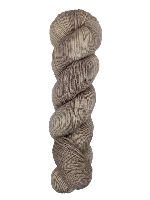 A skein of hand-dyed fingering/sock yarn color off-white and grey 
