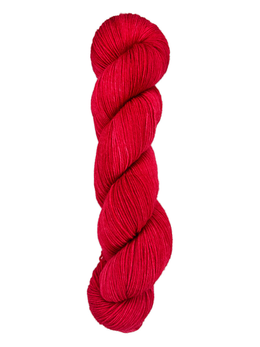 A skein of hand-dyed fingering/sock yarn color red