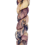 A skein of hand-dyed fingering/sock yarn color mauve off white purple navy black speckles