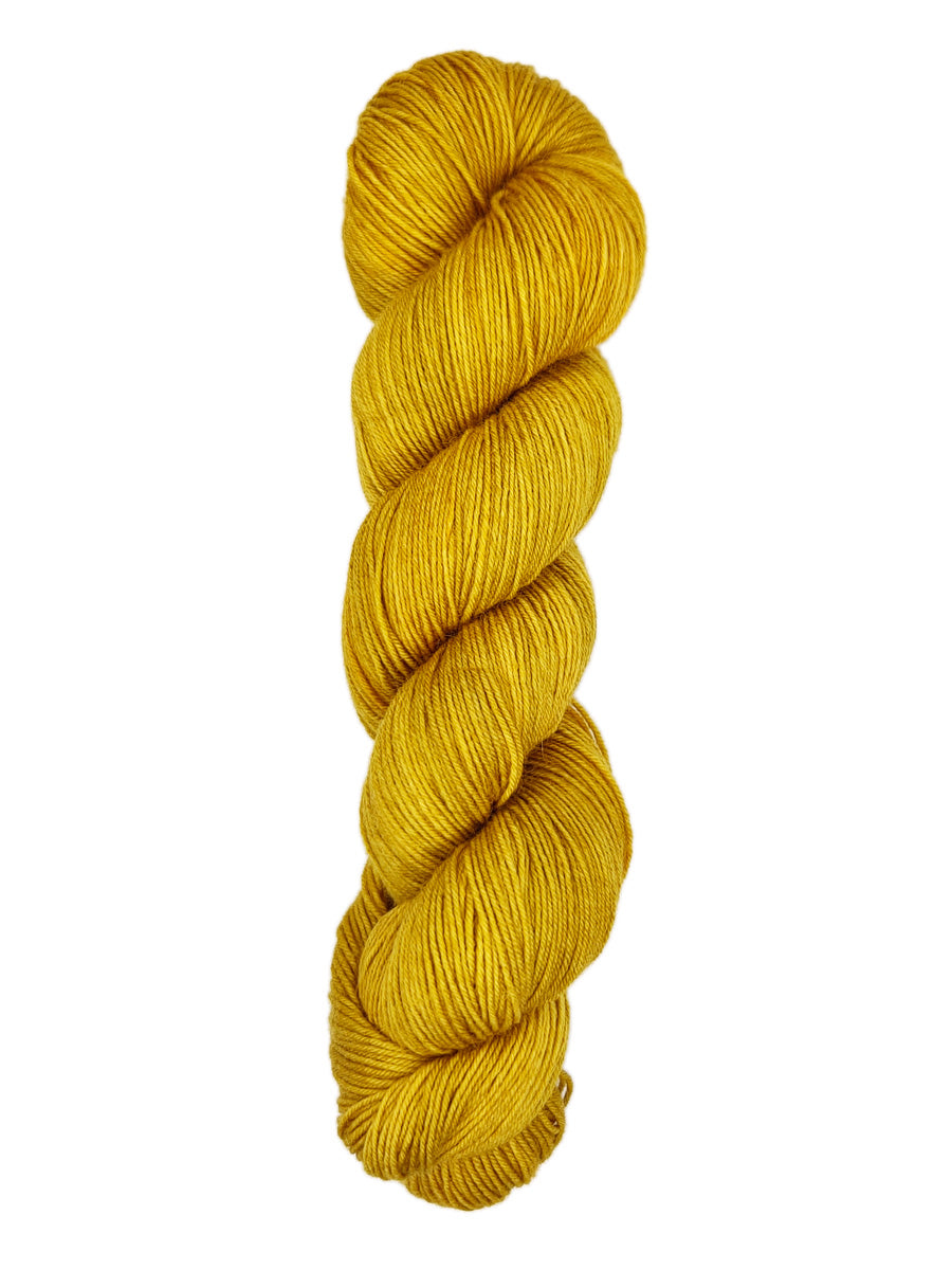 A skein of hand-dyed fingering/sock yarn color golden yellow