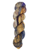 A skein of hand-dyed fingering/sock yarn color grey tan brown navy black speckles