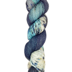 A skein of hand-dyed fingering/sock yarn color sky blue black white grey speckles