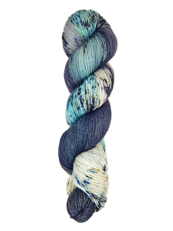 A skein of hand-dyed fingering/sock yarn color sky blue black white grey speckles