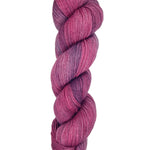 A skein of hand-dyed fingering/sock yarn color pink purple