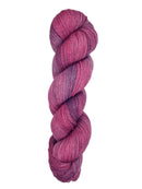 A skein of hand-dyed fingering/sock yarn color pink purple