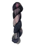 A skein of hand-dyed fingering/sock yarn color black mauve grey pink mild speckles
