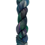 A skein of hand-dyed fingering/sock yarn color blue teal green purple grey