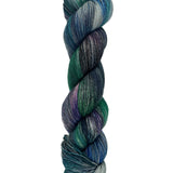 A skein of hand-dyed fingering/sock yarn color blue teal green purple grey