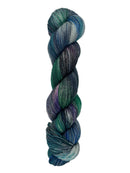 A skein of hand-dyed fingering/sock yarn color blue teal green purple grey