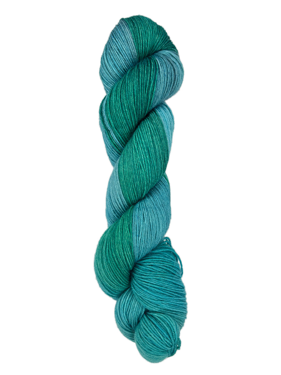 A skein of hand-dyed fingering/sock yarn color blue teal green 