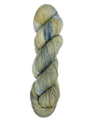 A skein of hand-dyed fingering/sock yarn color grey tan navy speckles