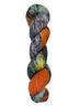 A skein of hand-dyed fingering/sock yarn color grey orange yellow dark green speckles