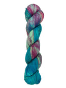 A skein of hand-dyed fingering/sock yarn color green blue pink purple speckles