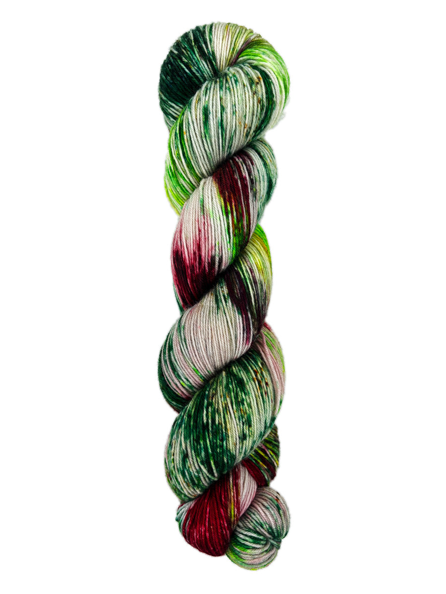 A skein of hand-dyed fingering/sock yarn color color red green brown speckles
