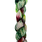 A skein of hand-dyed fingering/sock yarn color color red green brown speckles