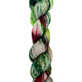 A skein of hand-dyed fingering/sock yarn color color red green brown speckles