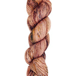 A skein of hand-dyed fingering/sock yarn color pink brown orange mauve speckles