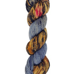 A skein of hand-dyed fingering/sock yarn color grey brown red black speckles