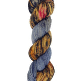 A skein of hand-dyed fingering/sock yarn color grey brown red black speckles