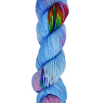 A skein of hand-dyed fingering/sock yarn color blue purple red green speckles