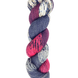 A skein of hand-dyed fingering/sock yarn color red black grey white speckles