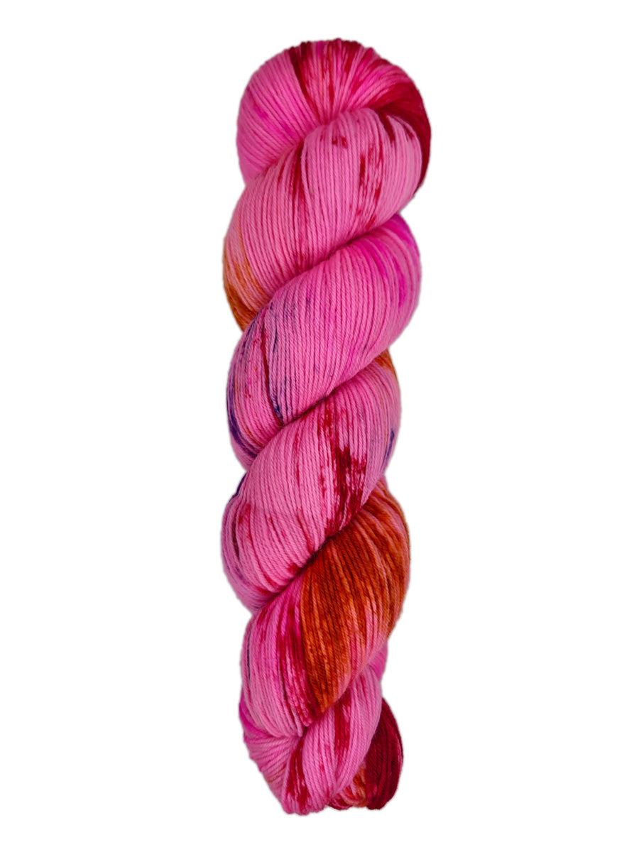 A skein of hand-dyed fingering/sock yarn color pink red orange navy speckles