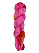 A skein of hand-dyed fingering/sock yarn color pink red orange navy speckles