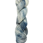 A skein of hand-dyed fingering/sock yarn color white grey blue mild speckling