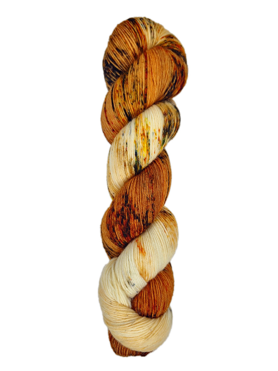 A skein of hand-dyed fingering/sock yarn color white orange red yellow black speckles