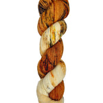 A skein of hand-dyed fingering/sock yarn color white orange red yellow black speckles