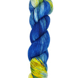 A skein of hand-dyed fingering/sock yarn color white yellow blue 