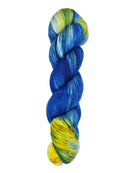 A skein of hand-dyed fingering/sock yarn color white yellow blue 