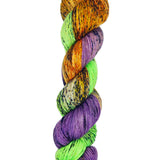 A skein of hand-dyed fingering/sock yarn color orange green purple black speckles