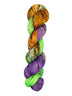 A skein of hand-dyed fingering/sock yarn color orange green purple black speckles