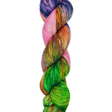 A skein of hand-dyed fingering/sock yarn color pink orange green navy speckles