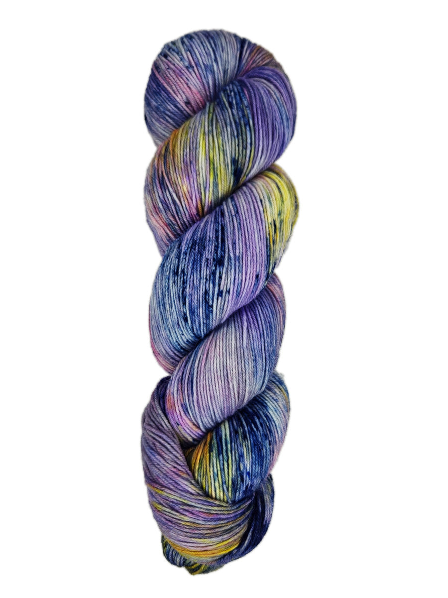 A skein of hand-dyed fingering/sock yarn color purple yellow pink navy black speckles