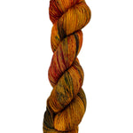 A skein of hand-dyed fingering/sock yarn color burnt orange red brown green speckles