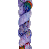 A skein of hand-dyed fingering/sock yarn color purple red green blue red orange speckles