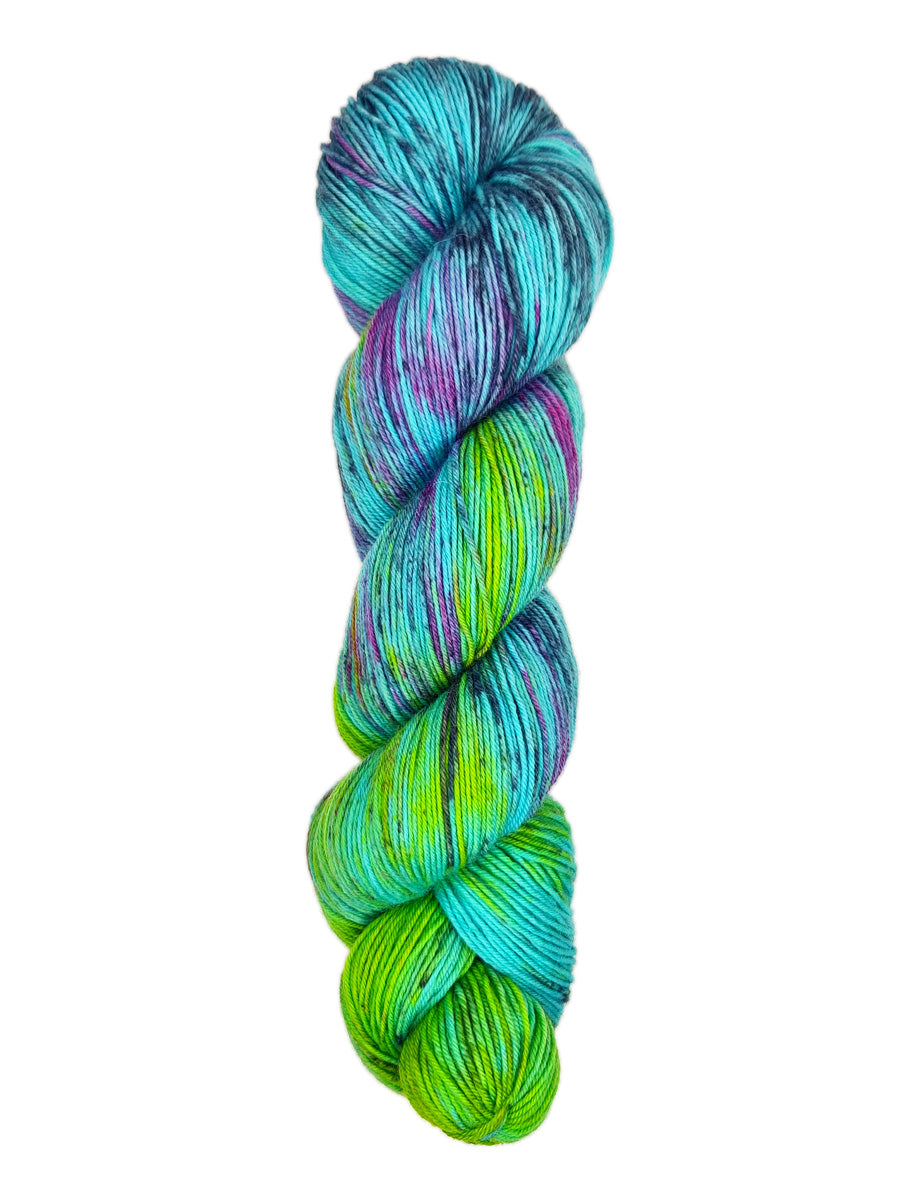 A skein of hand-dyed fingering/sock yarn color blue purple green navy black speckles