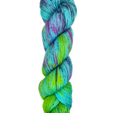 A skein of hand-dyed fingering/sock yarn color blue purple green navy black speckles