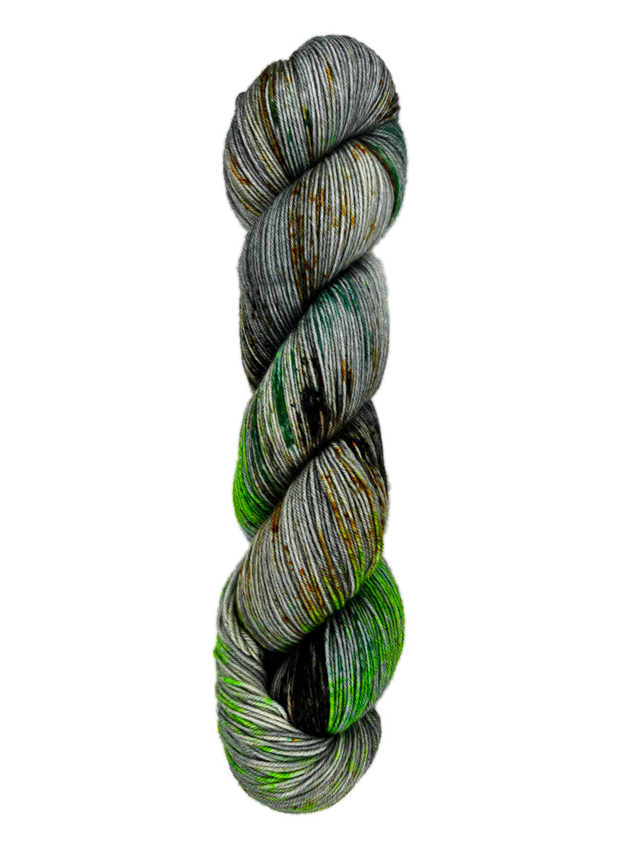 A skein of hand-dyed fingering/sock yarn color grey green  orange brown speckles