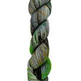A skein of hand-dyed fingering/sock yarn color grey green  orange brown speckles