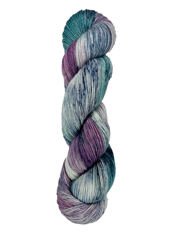 A skein of hand-dyed fingering/sock yarn color teal purple grey navy speckles