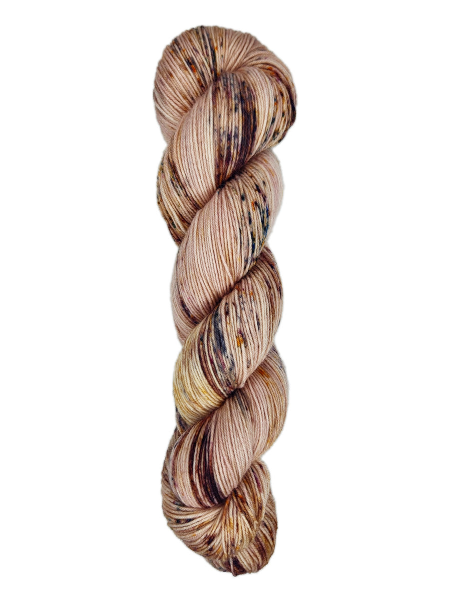 A skein of hand-dyed fingering/sock yarn color pink brown burgundy speckles