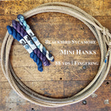 Mini Skeins of Blackbird Sycamore Yarn on a wooden surface